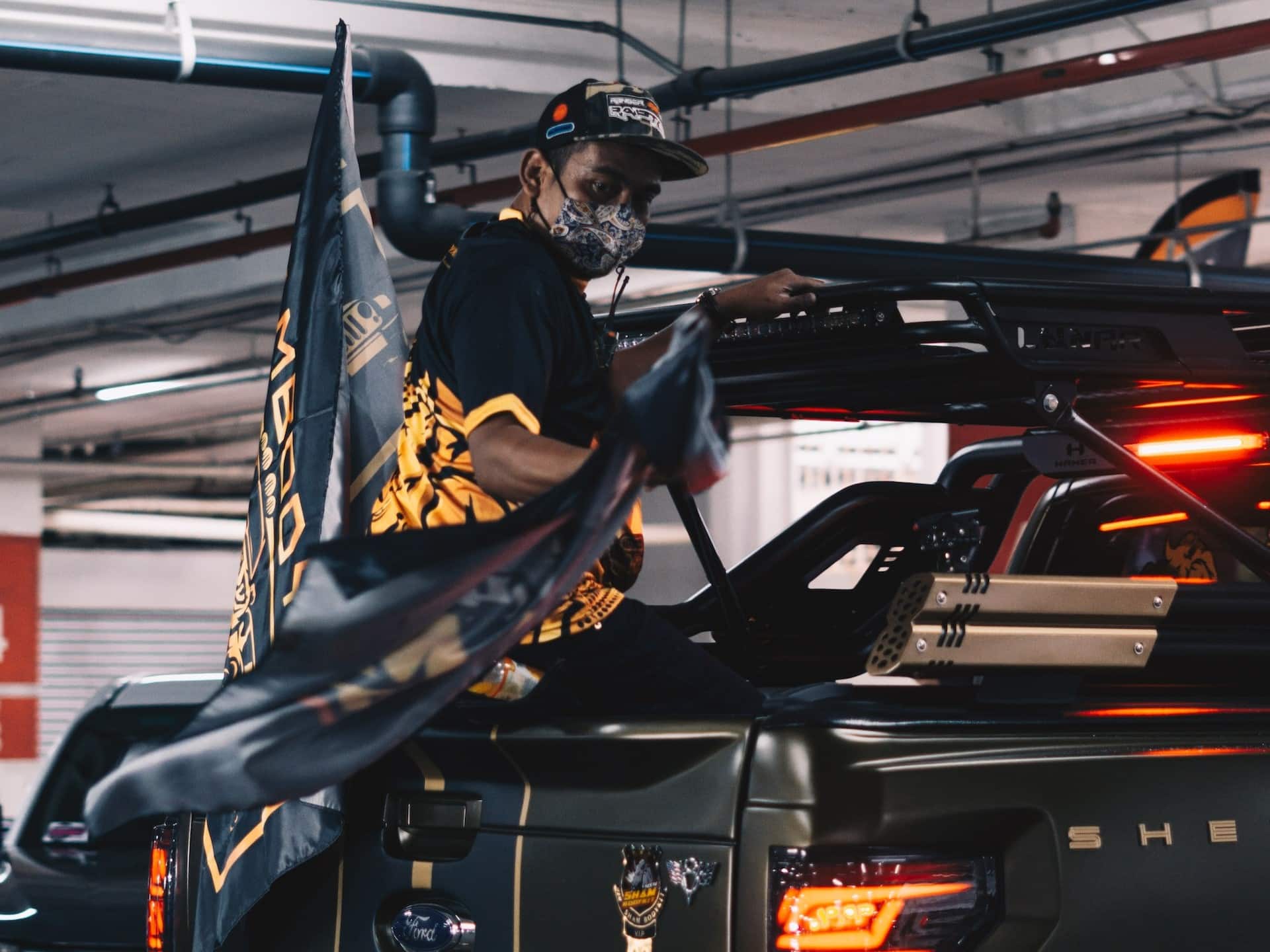 a worker puts a new part on a ford