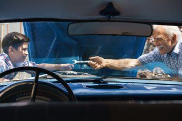 Grandpa and grandson fixing car