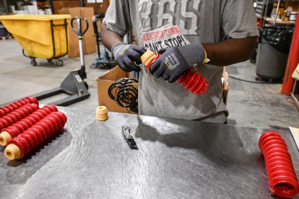 a strutmasters employee assembles a kit